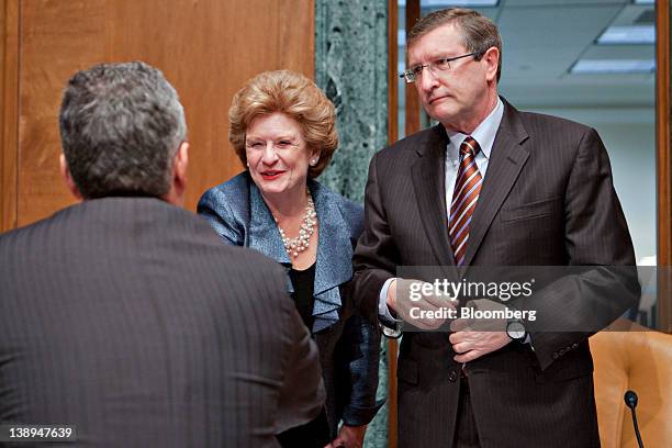 Jeffrey Zients, acting director of the Office of Management and Budget , left, greets Senator Kent Conrad, a Democrat from North Dakota, right, and...