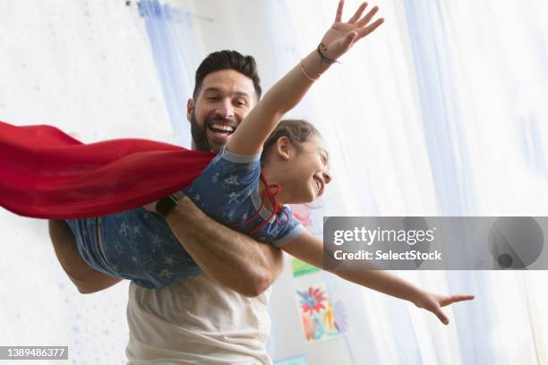 father and daughter playing together - super hero capes stock pictures, royalty-free photos & images