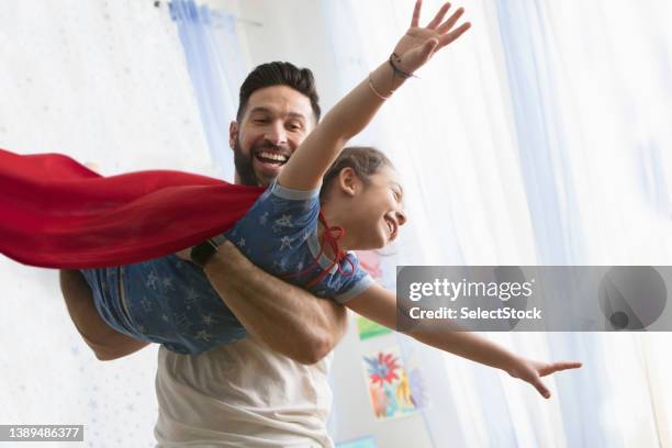 father and daughter playing together - cape garment stock pictures, royalty-free photos & images