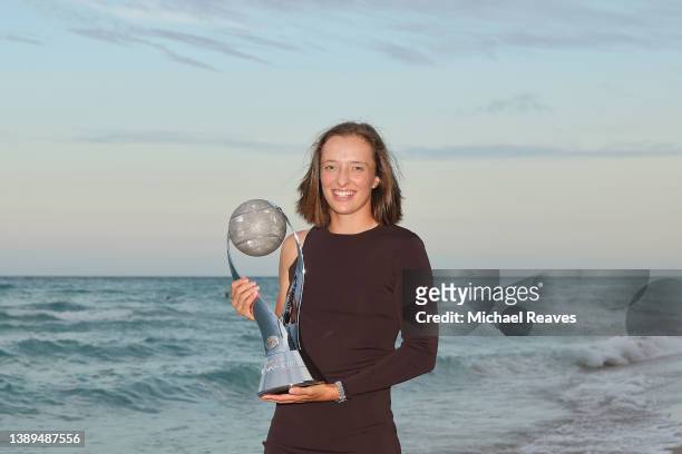 In this image released on April 4, Iga Swiatek of Poland poses with the Chris Evert WTA World No.1 Trophy on April 02, 2022 in Hollywood Beach,...