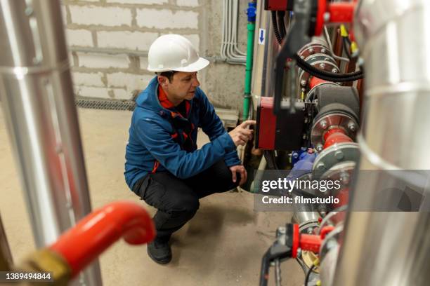 engineer is inspecting heating system in boiler room - water pump stock pictures, royalty-free photos & images