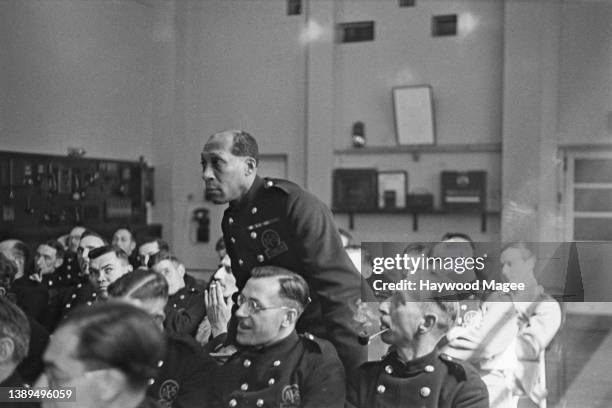 Trinidadian civil rights activist, firefighter and soldier George Arthur Roberts , wearing his London Auxiliary Fire Service uniform, stands to...