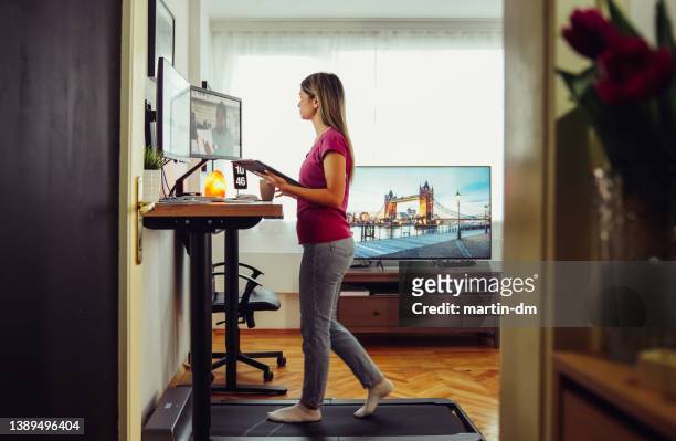 standing desk home office with under desk treadmill - businesswoman under stock pictures, royalty-free photos & images