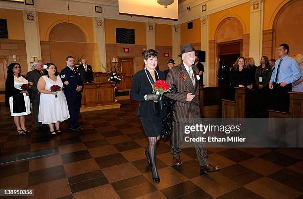 Victoria Luginbill and Thomas Luginbill of Washington walk down an aisle after renewing their wedding vows in a courtroom that was the site of the...