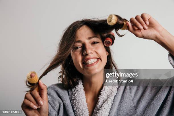 preparing for the day with a smile on her face - female curler stock pictures, royalty-free photos & images