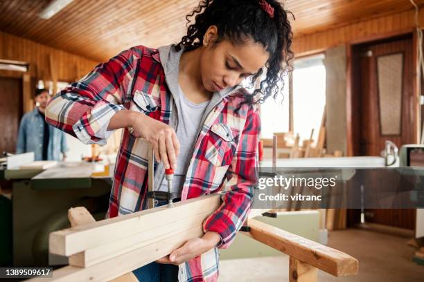 mulheres trabalhando em oficina de carpinteiro - braçadeira - fotografias e filmes do acervo