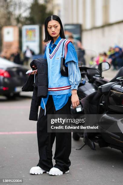 Guest wears a blue short sleeves shirt, a blue and white striped print pattern shirt , a pale blue with red and white V-neck collar / sleeveless wool...