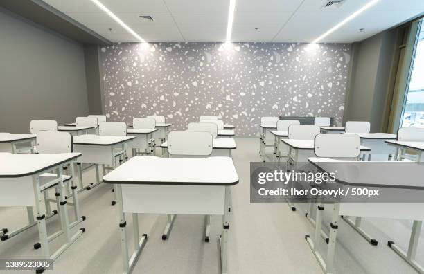 new school room with desks and chairs in white color - classroom wide angle stock pictures, royalty-free photos & images