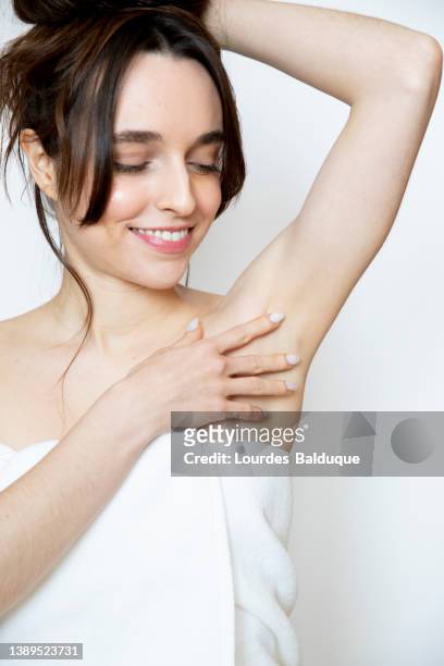 cropped image of woman touching armpit - deodorant stock-fotos und bilder