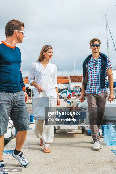 young couple arriving to marina for sailing - yachting stockfoto's en -beelden