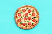 Vegetarian pizza above view, minimalist on a blue background