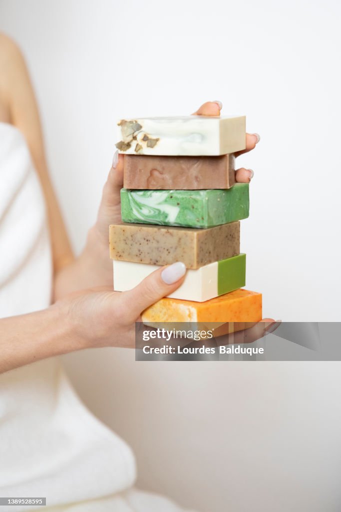 Woman's hand holding handmade soaps