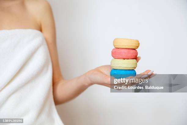 woman's hand holding handmade soaps - homemade soap stock pictures, royalty-free photos & images