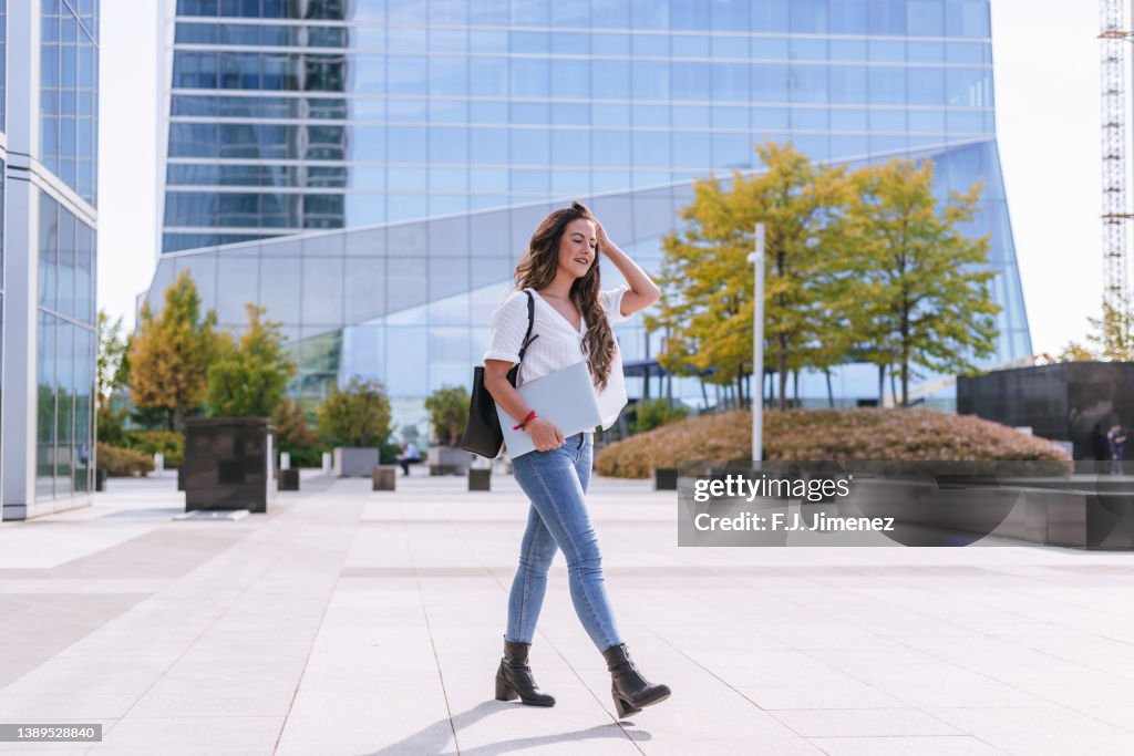 Working woman walking through business district