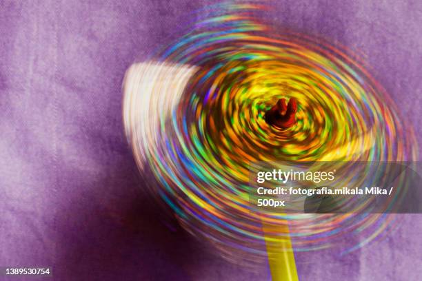 close-up of spinning wheel on purple fabric - spinnrad stock-fotos und bilder