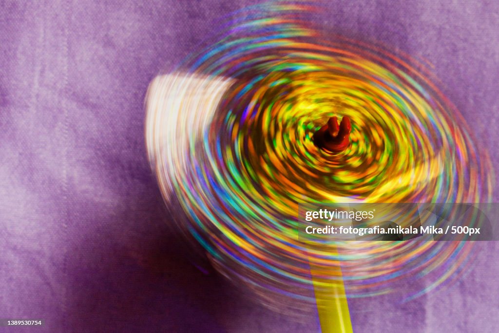 Close-up of spinning wheel on purple fabric