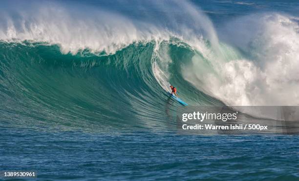 person surfing on big wave in sea during day - big wave stock pictures, royalty-free photos & images