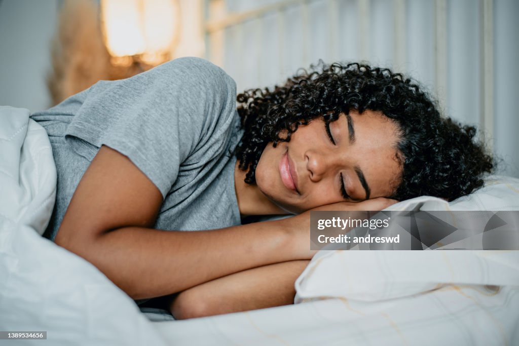 Teenager sleeping in bed