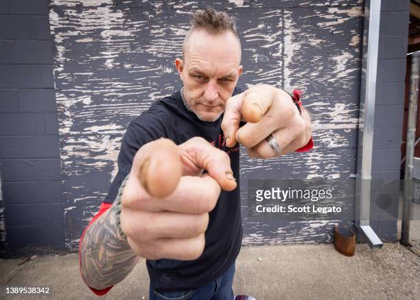 Detroit Red Wings hockey legend Darren McCarty poses at Rustbelt Studio with his rock band Grinder on April 03, 2022 in Royal Oak, Michigan.