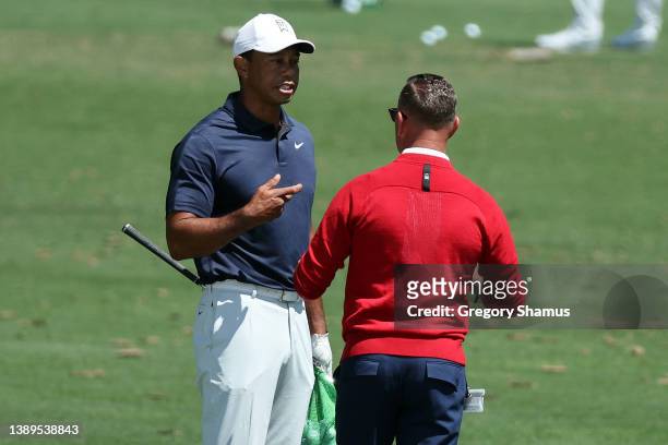 Tiger Woods of the United States talks to coach Sean Foley on the range during a practice round prior to the Masters at Augusta National Golf Club on...
