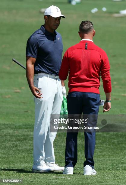 Tiger Woods of the United States talks to coach Sean Foley on the range during a practice round prior to the Masters at Augusta National Golf Club on...