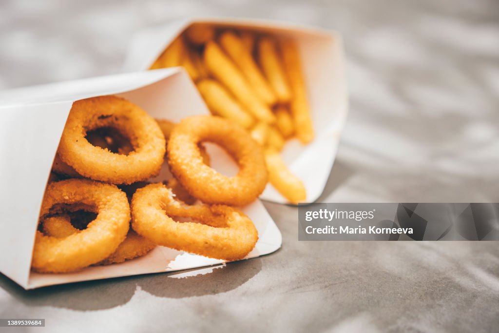Deep-fried onion rings and French Fries.