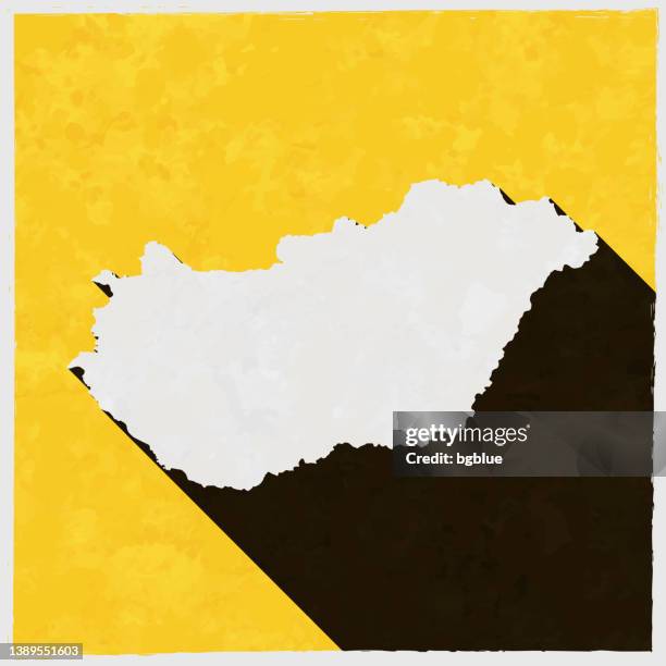 hungary map with long shadow on textured yellow background - budapest stock illustrations