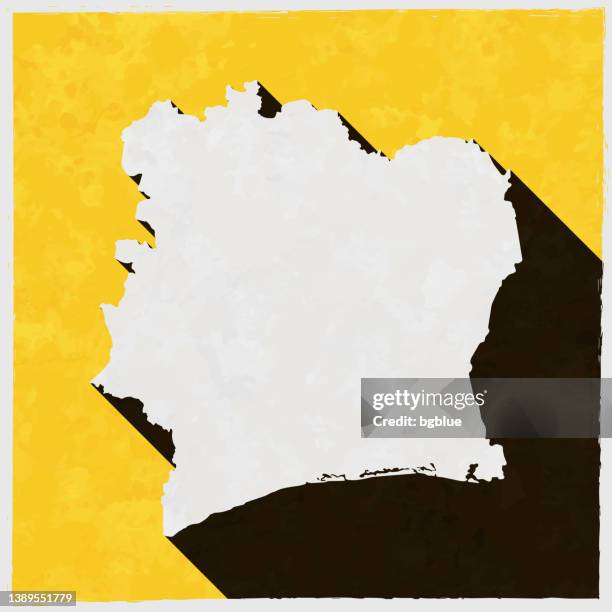 bildbanksillustrationer, clip art samt tecknat material och ikoner med ivory coast map with long shadow on textured yellow background - elfenbenskusten