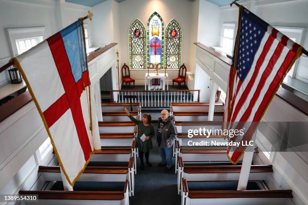 Administrator Denise Conte, left, and volunteer Bill Taylor speak on March 26 inside the historic St. John Episcopal Church, built in 1765, in...