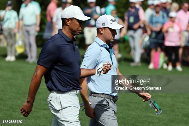 Tiger Woods of the United States and Justin Thomas of the United States walk on the fifth hole during a practice round prior to the Masters at...
