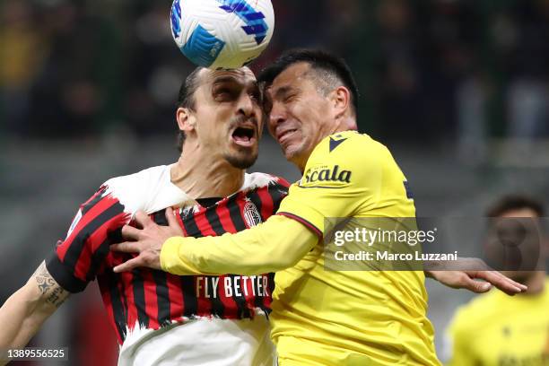 Zlatan Ibrahimovic of AC Milan clashes heads with Gary Medel of Bologna during the Serie A match between AC Milan and Bologna FC at Stadio Giuseppe...