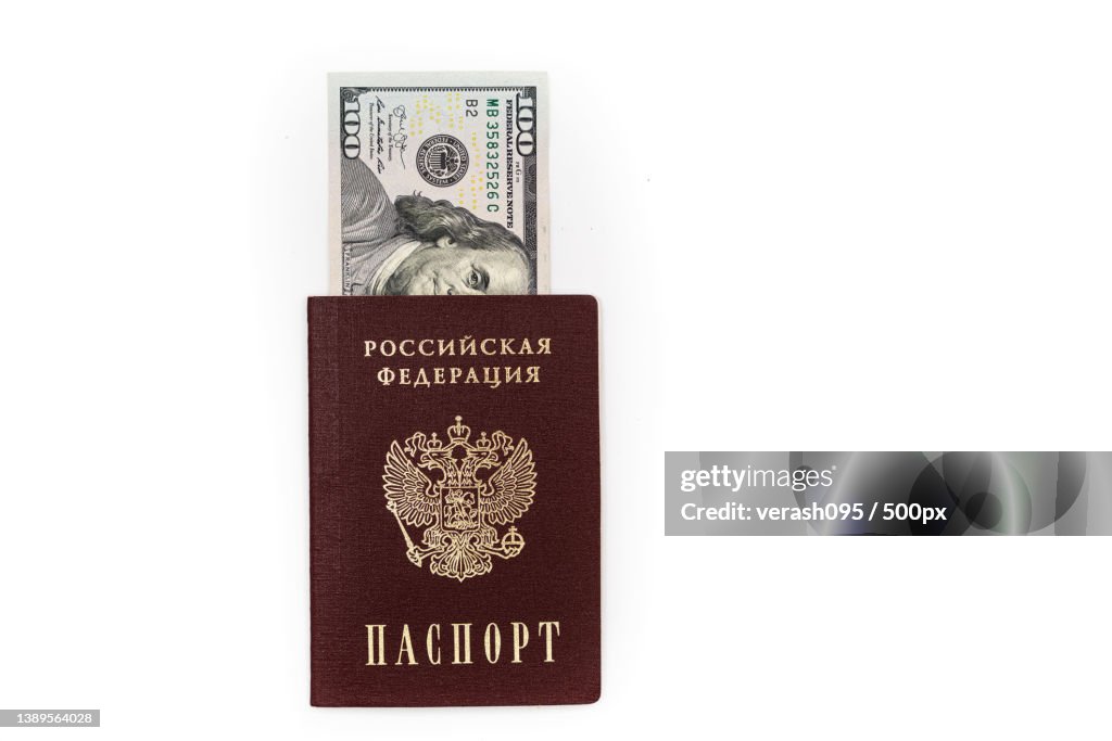 100 dollar bills lie in the passport of the Russian Federation