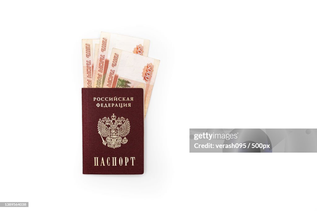 Russian passport with banknotes of 5000 rubles on a white background