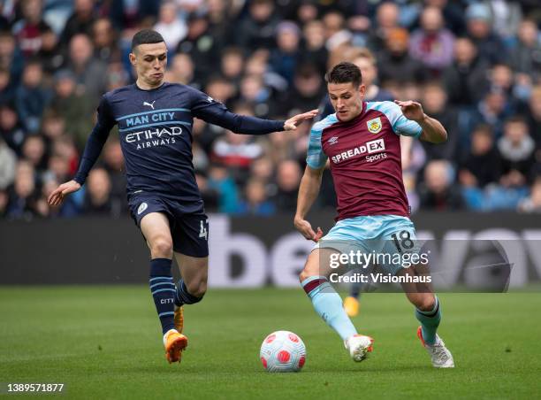 Ashley Westwood of Burnley and Phil Foden of Manchester City in action during the Premier League match between Burnley and Manchester City at Turf...