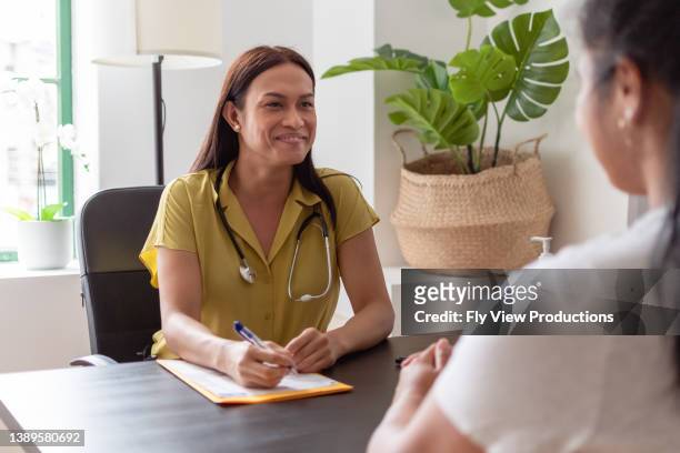 cheerful female doctor meeting with a patient - expert advice stock pictures, royalty-free photos & images