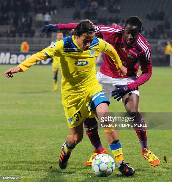 Apoel Nicosia's Portuguese midfielder Hélder Bruno Macedo Sousa vies with Lyon's French defender Aly Cissokho during the UEFA Champion's League...