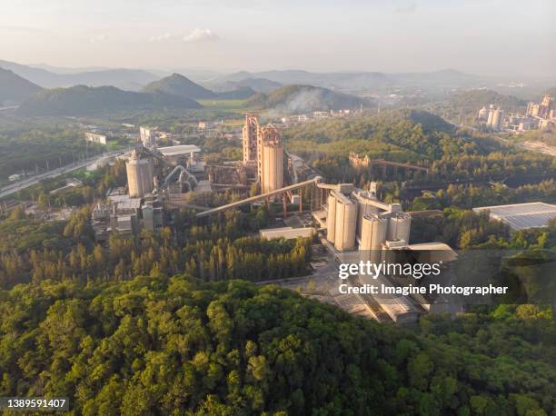 aerial view, golden hour cement plant business construction industrial in valley. - cement factory stock pictures, royalty-free photos & images