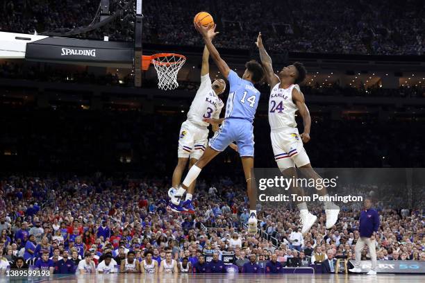 Puff Johnson of the North Carolina Tar Heels shoots the ball as Dajuan Harris Jr. #3 and K.J. Adams of the Kansas Jayhawks defend in the first half...