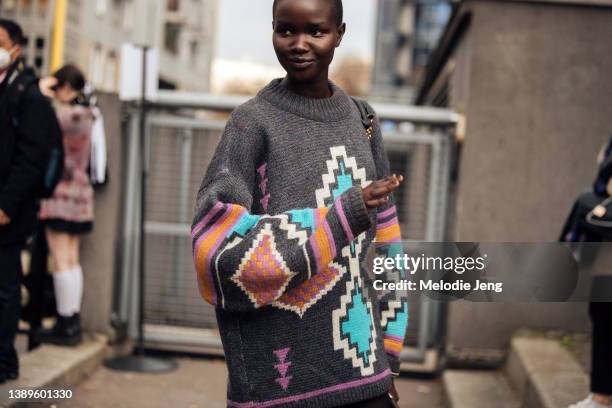 Model Akon Changkou wears a gray and pink Isabel Marant Étoile print sweater after the Ludovic de Saint Sernin show during Paris Fashion Week...