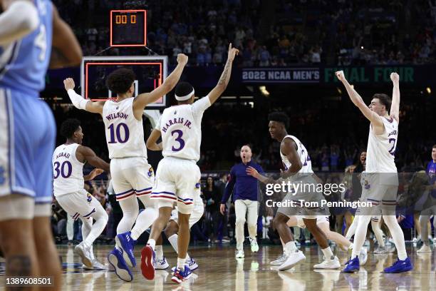 Kansas Jayhawks players react after defeating the North Carolina Tar Heels 72-69 during the 2022 NCAA Men's Basketball Tournament National...