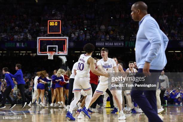 Jalen Wilson of the Kansas Jayhawks celebrates with a teammate after defeating the North Carolina Tar Heels 72-69 during the 2022 NCAA Men's...