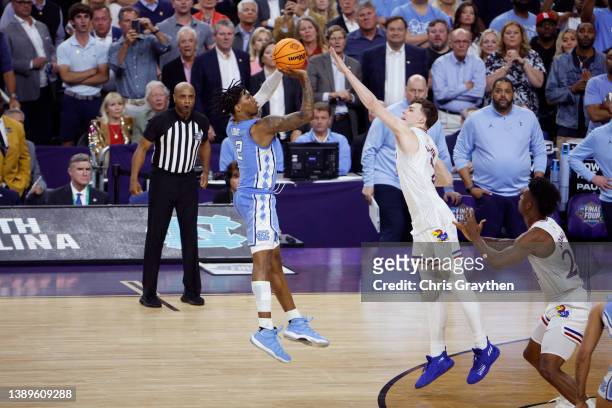 Christian Braun of the Kansas Jayhawks attempts to block a shot by Caleb Love of the North Carolina Tar Heels in the second half of the game during...