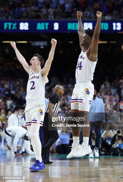 Christian Braun and K.J. Adams of the Kansas Jayhawks react after defeating the North Carolina Tar Heels 72-69 during the 2022 NCAA Men's Basketball...