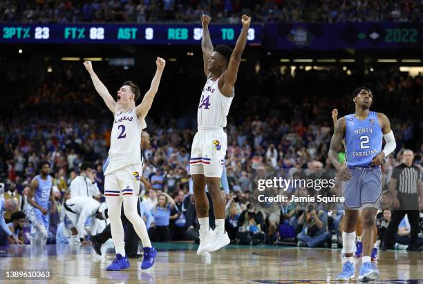 Christian Braun and K.J. Adams of the Kansas Jayhawks react after defeating the North Carolina Tar Heels 72-69 during the 2022 NCAA Men's Basketball...