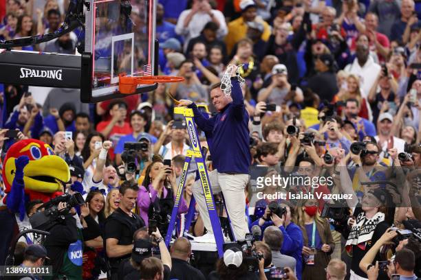 Head coach Bill Self of the Kansas Jayhawks cuts down the net after defeating the North Carolina Tar Heels during the second half of the 2022 NCAA...