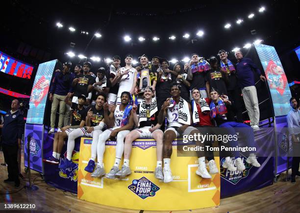 The Kansas Jayhawks pose for a picture after defeating the North Carolina Tar Heels 72-69 during the 2022 NCAA Men's Basketball Tournament National...