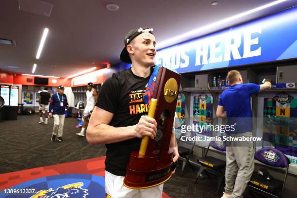 Christian Braun of the Kansas Jayhawks celebrates with the trophy after defeating the North Carolina Tar Heels to win the 2022 NCAA Men's Basketball...