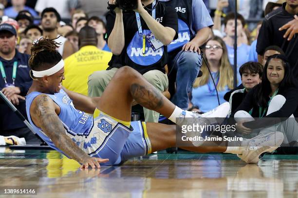 Armando Bacot of the North Carolina Tar Heels reacts in pain in the second half of the game against the Kansas Jayhawks during the 2022 NCAA Men's...