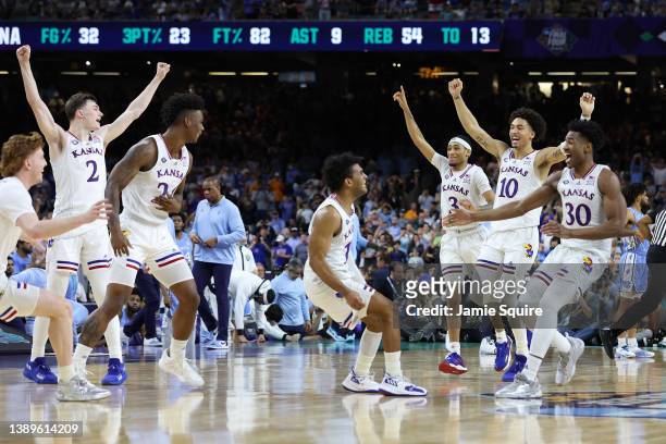 Kansas Jayhawks players celebrate after defeating the North Carolina Tar Heels 72-69 during the 2022 NCAA Men's Basketball Tournament National...