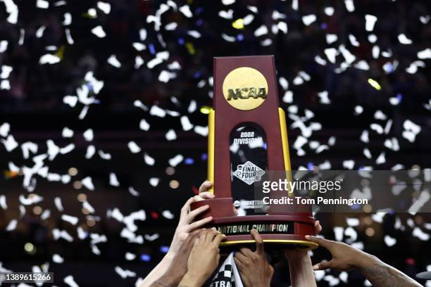 The Kansas Jayhawks celebrate with the trophy after defeating the North Carolina Tar Heels 72-69 during the 2022 NCAA Men's Basketball Tournament...